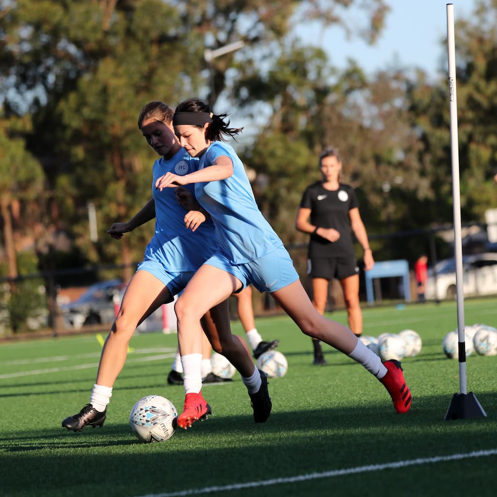 Female soccer players being coached in Canberra.